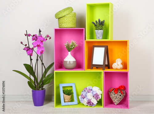 Fotografie Beautiful colorful shelves with different home related objects