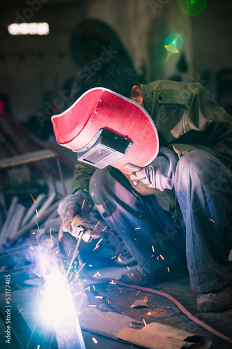Chinese worker welding metal