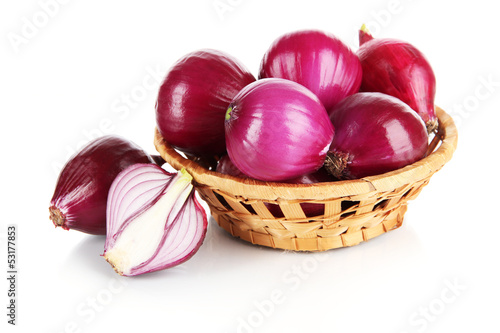 Purple onion in wicker basket isolated on white