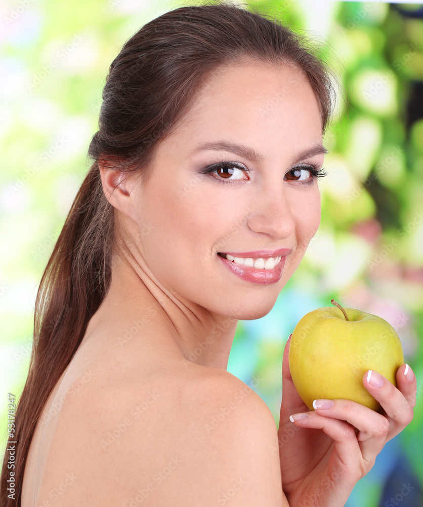 Smiling woman with apple on bright background Smiling woman with apple on bright background