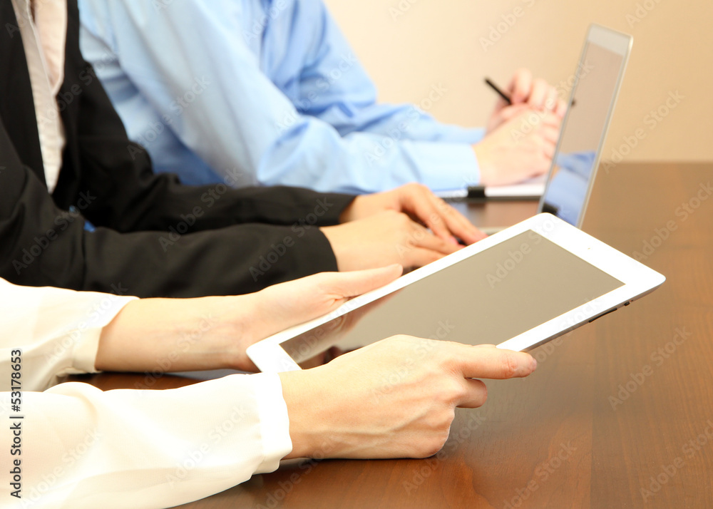 Female hands with digital tablet on office background. Female hands with digital tablet on office background.