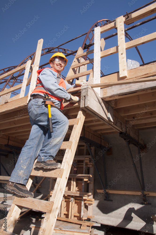 Construction worker climbing ladder