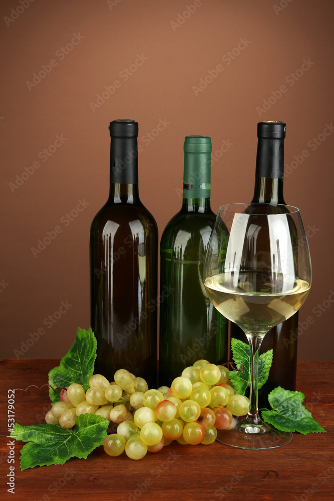 Composition of wine bottles, glass of white wine, grape