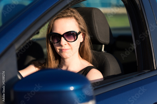 Beautiful businesswoman in sunglasses driving in the car © len44ik