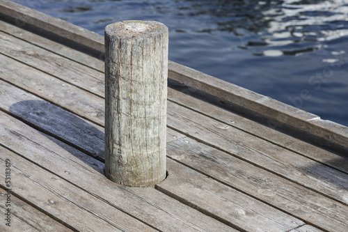 Old mooring bollard on wooden pier
