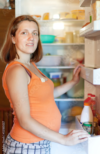  woman looking for something in refrigerator