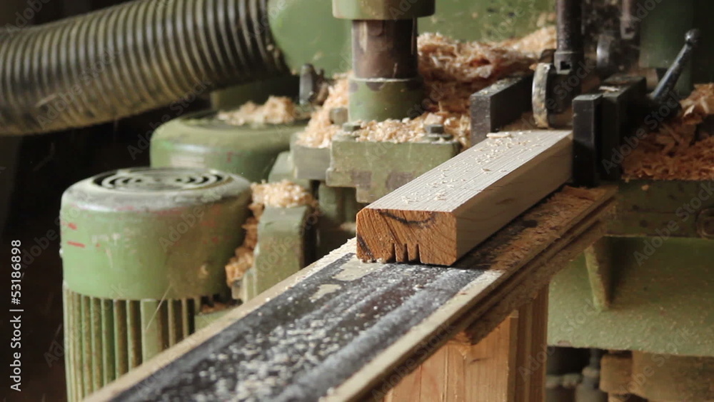 Wooden bar comes from wood grinding machine, dolly shot Wooden bar comes from wood grinding machine, dolly shot