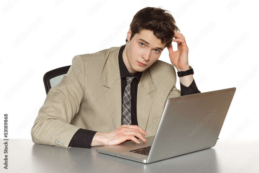 Business man sitting the table with laptop, scratching his head Business man sitting the table with laptop, scratching his head