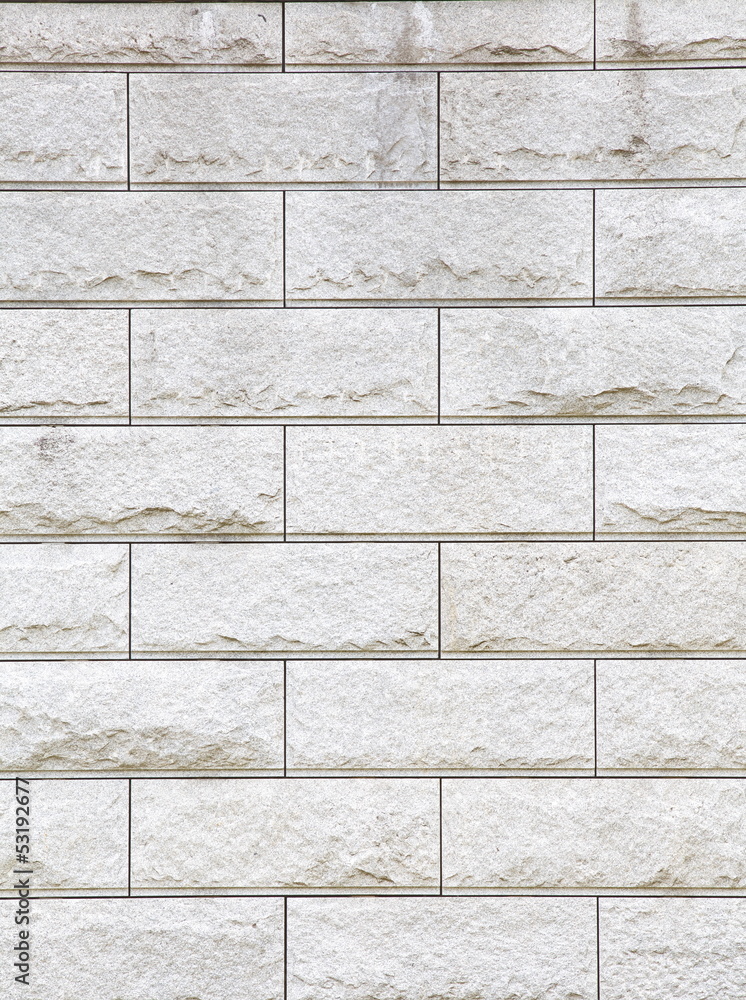 Fototapeta premium Several rows of a rough textured concrete block wall