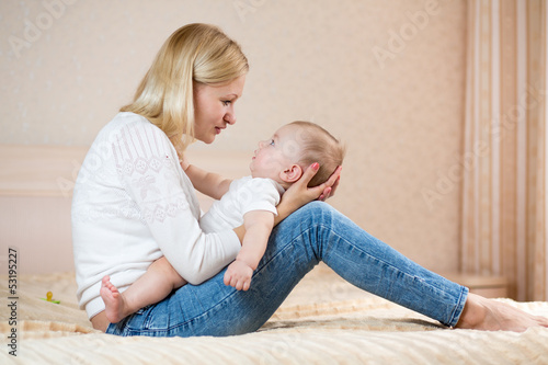 mother playing with baby bo...