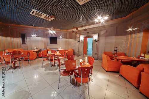 Interior of small empty cafe in orange tones