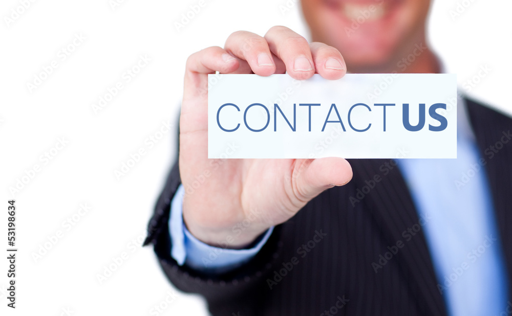 Businessman holding a label with contact us written on it Businessman holding a label with contact us written on it