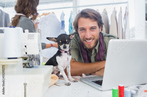 Smiling fashion designer with his chihuahua
