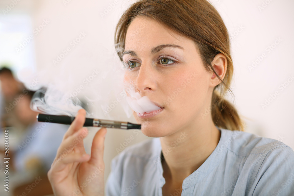 Portrait of woman smoking with electronic cigarette Portrait of woman smoking with electronic cigarette