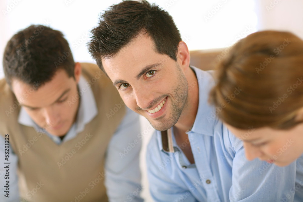 Smiling handsome man working in office Smiling handsome man working in office