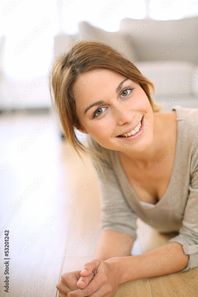 Smiling girl relaxing on the floor at home Smiling girl relaxing on the floor at home