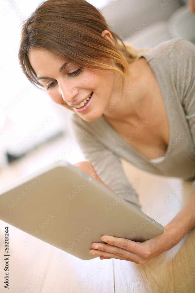 Smiling girl websurfing on internet with tablet Smiling girl websurfing on internet with tablet