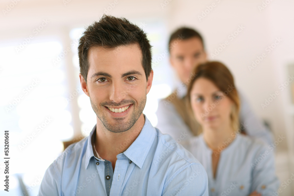 Handsome man standing in front of business team Handsome man standing in front of business team