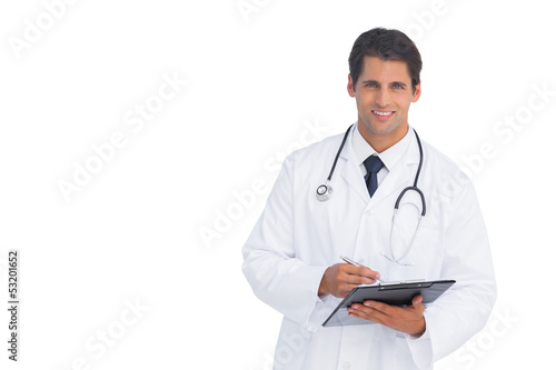 Smiling doctor holding a clipboard and pen