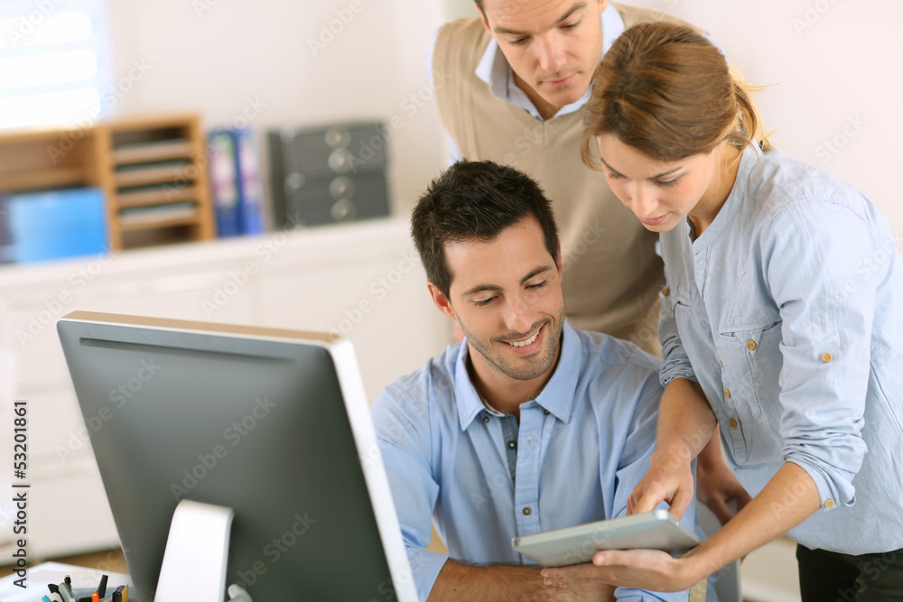 Office workers using tablet and computer Office workers using tablet and computer