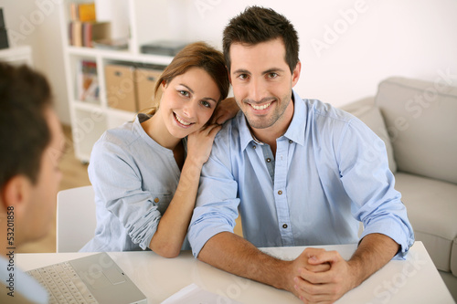 Smiling couple in real-estate agency