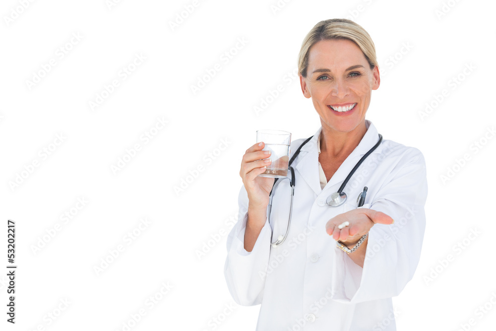 Smiling doctor holding out pills and water glass Smiling doctor holding out pills and water glass