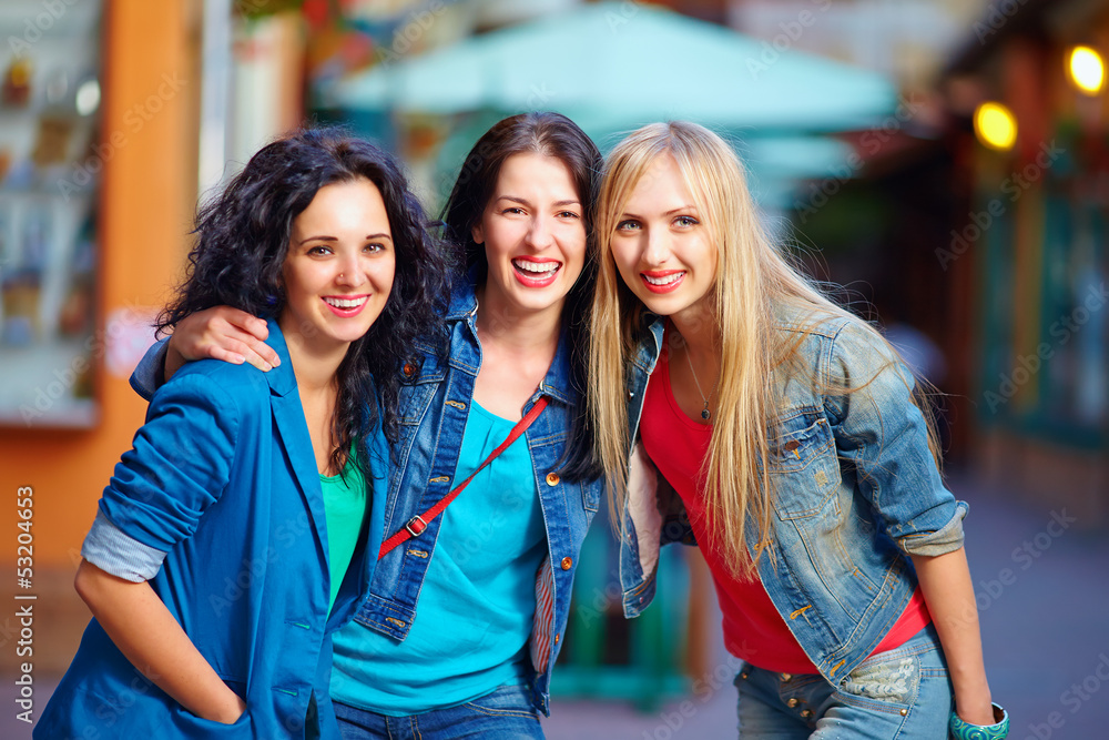 Fototapeta premium beautiful girls friends on evening city street