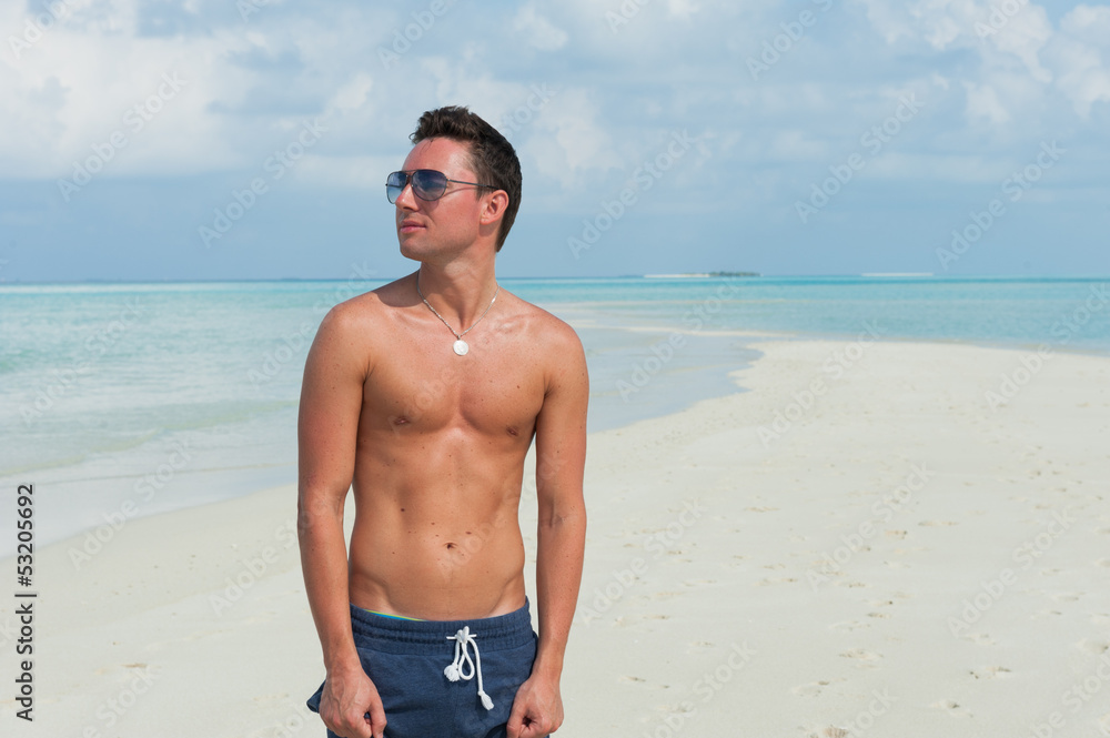 man stands on the beach with the blue sea and the beautiful sky man stands on the beach with the blue sea and the beautiful sky