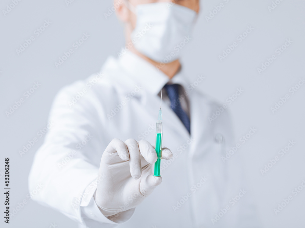 male doctor holding syringe with injection male doctor holding syringe with injection