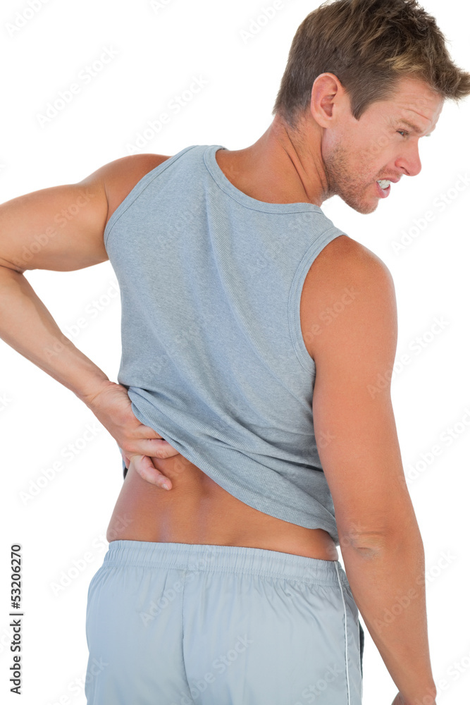 Man grimacing because of a back pain Man grimacing because of a back pain