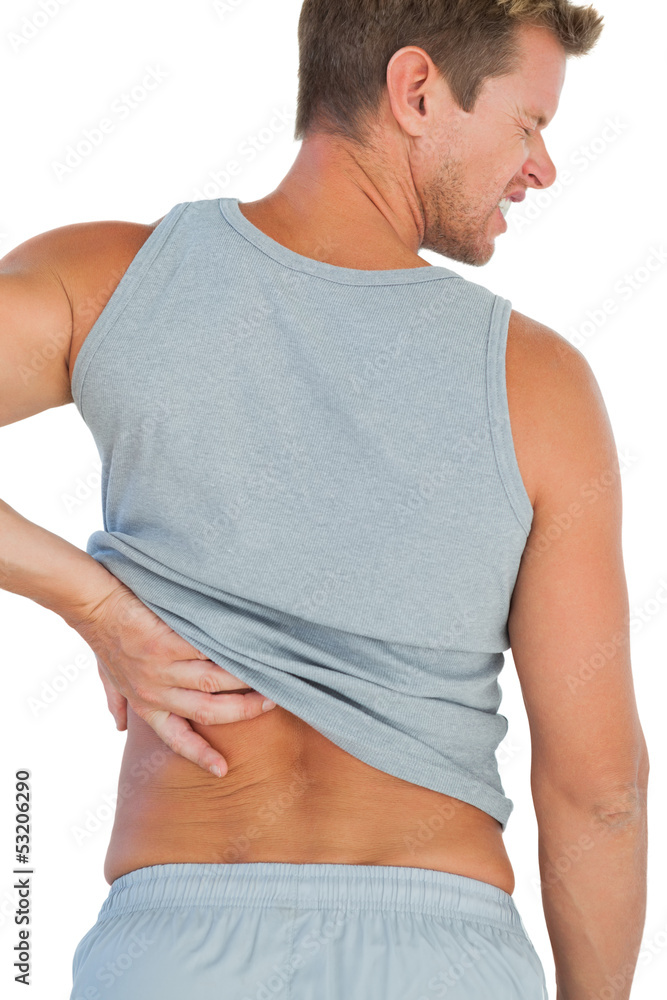 Man in tank top rubbing his back because of a back pain Man in tank top rubbing his back because of a back pain
