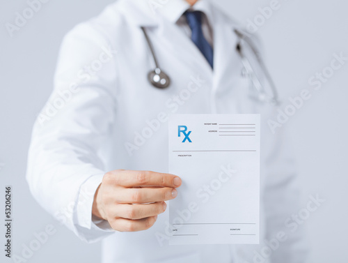 male doctor holding rx paper in hand photo