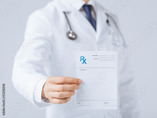 Photos male doctor holding rx paper in hand