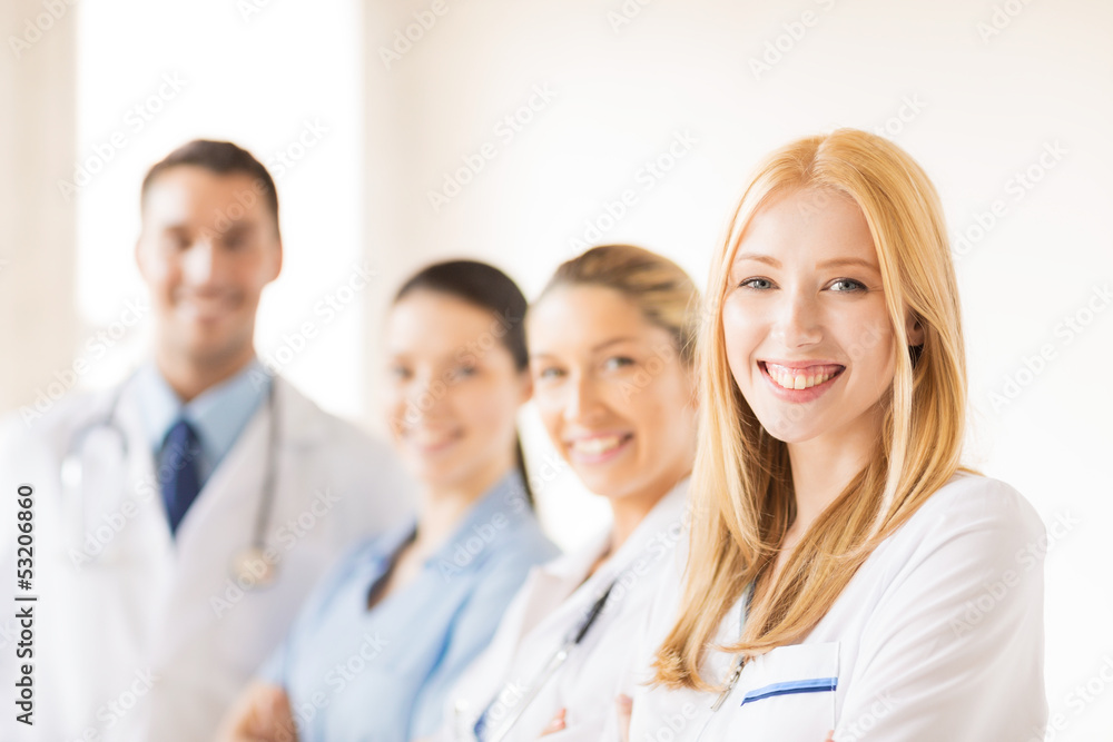 female doctor in front of medical group female doctor in front of medical group