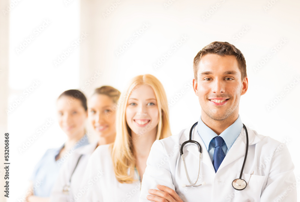 male doctor in front of medical group male doctor in front of medical group