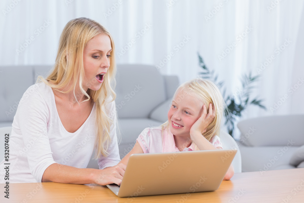 Mother and daughter using laptop Mother and daughter using laptop