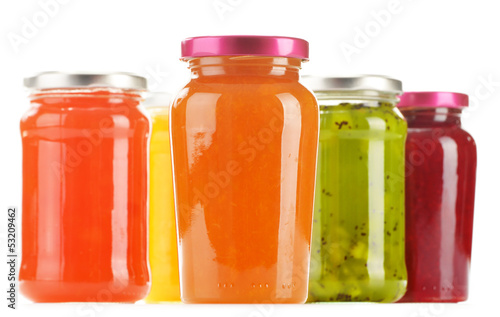 Jars of fruity jams isolated on white background