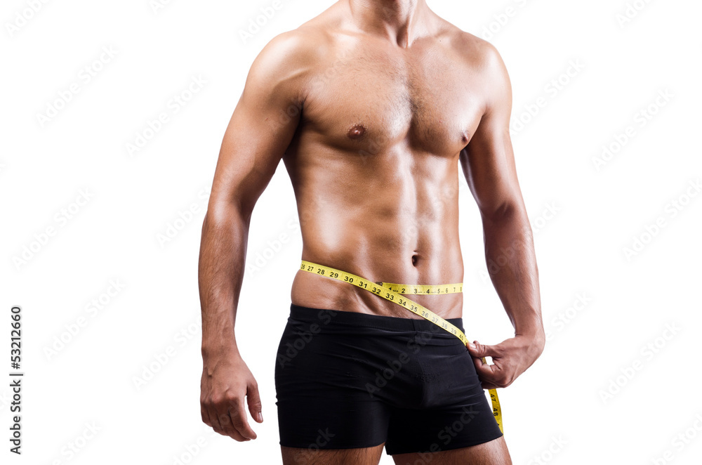 Fototapeta premium Muscular man measuring his muscles