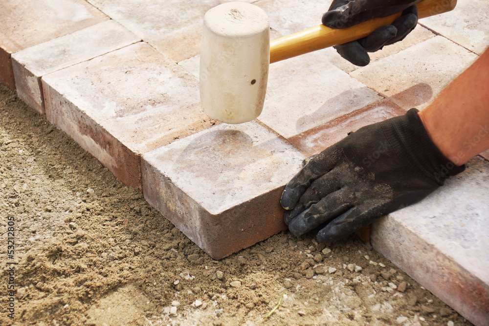 Using A Mallet Using a mallet to set paver Stock Photo | Adobe Stock