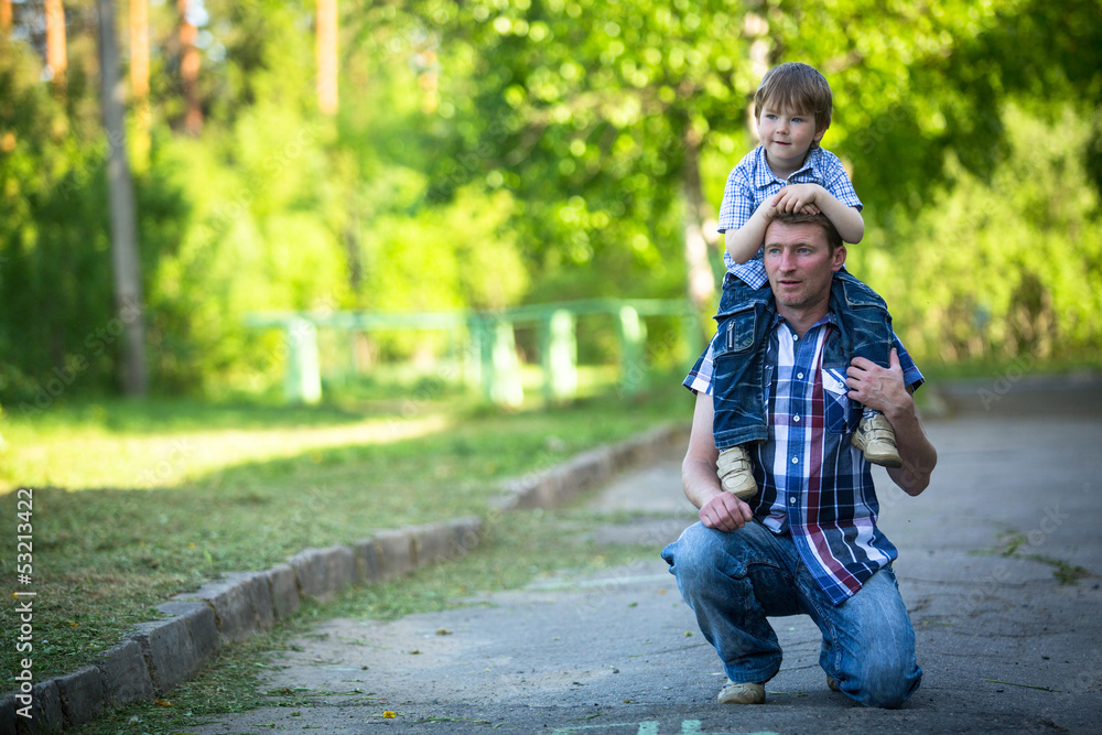 Portrait of father and son play outdoors Portrait of father and son play outdoors