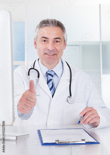 Mature Male Doctor Showing Thumbs Up Sign
