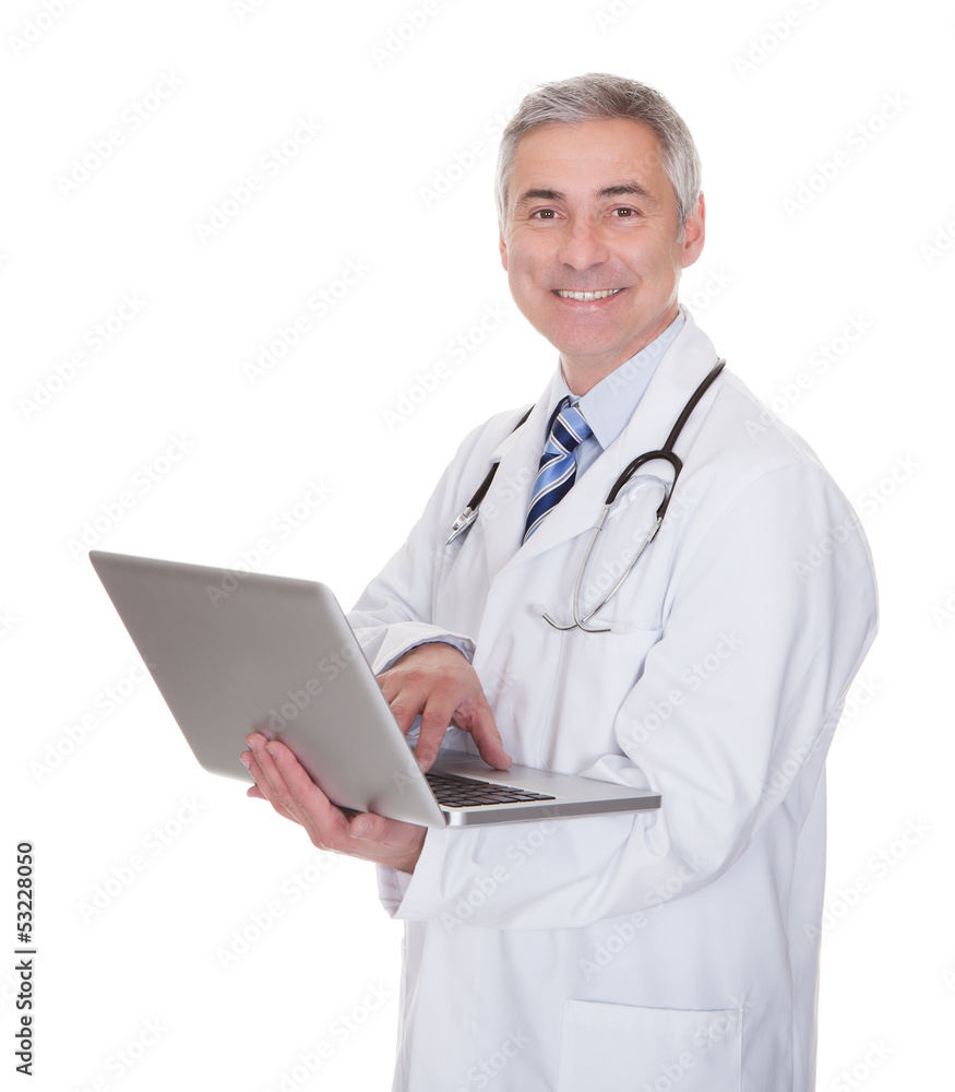 Portrait Of Male Doctor Using Laptop Portrait Of Male Doctor Using Laptop