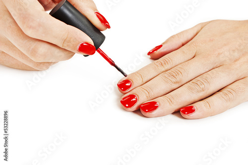 Manicure. Applying red nail polish