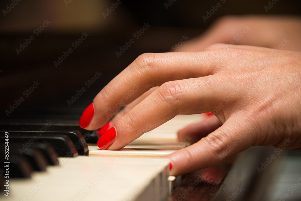 Obraz premium Female pianist hands closeup and piano keyboard