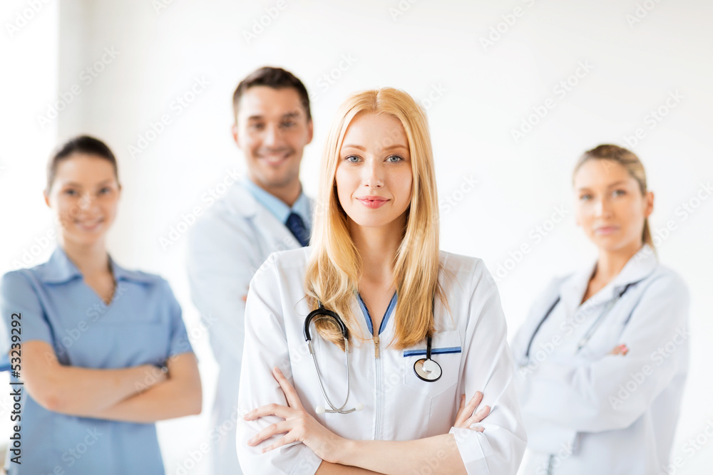 female doctor in front of medical group female doctor in front of medical group