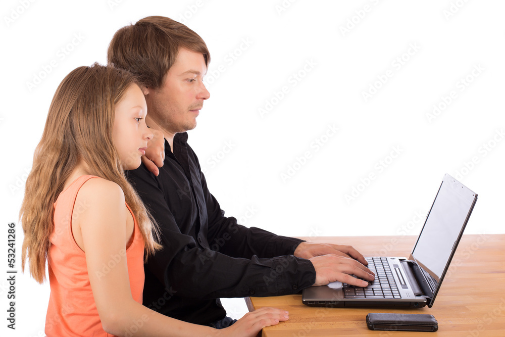 Father working with his daughter on a laptop Father working with his daughter on a laptop