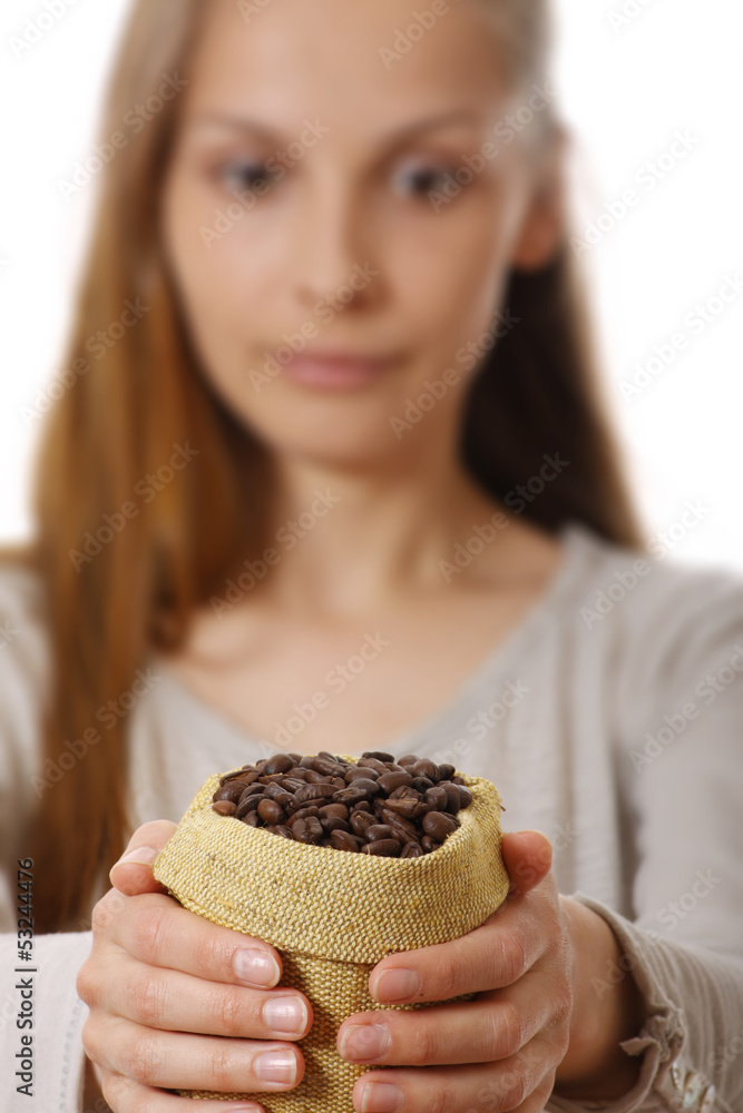 young woman holding a small bag of coffee beans young woman holding a small bag of coffee beans