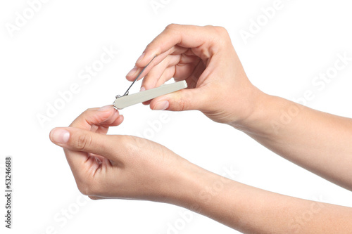 Woman hands using a nail clippers to cut her fingernails