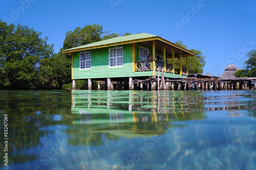 Tropical stilt house over the sea © dam