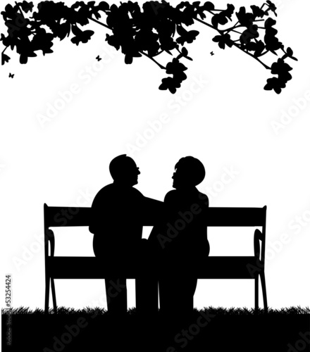 Lovely retired elderly couple sitting on bench in yard